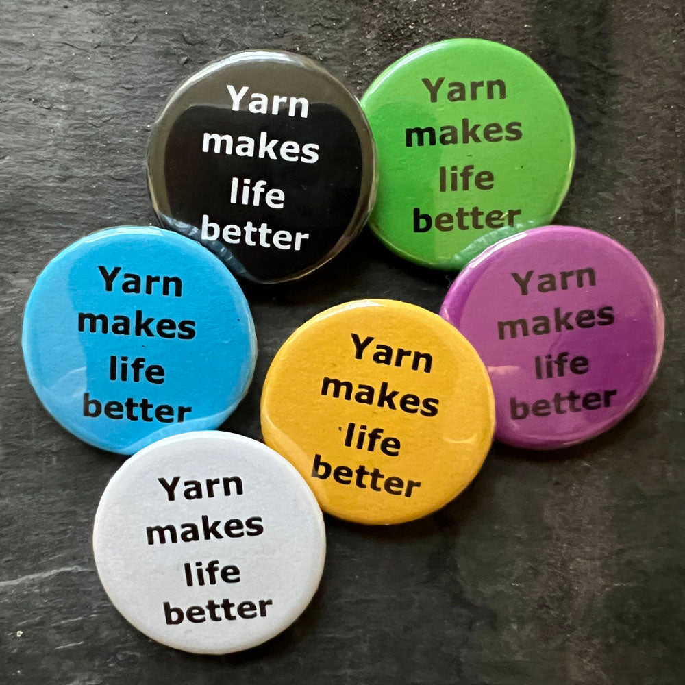 Six Yarn makes life better pin badges in black, blue, pink, green, yellow, and white.