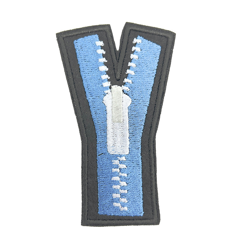 Close-up view of an embroidered felt patch shaped like an uppercase "Y". The patch features a blue zipper with white teeth and a white pull tab, depicted with black outlines and details.