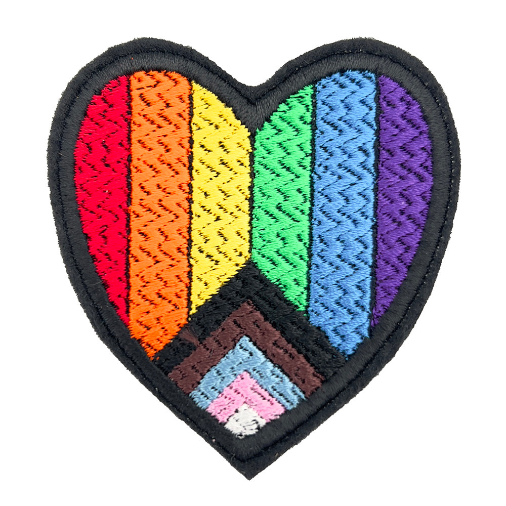Heart-shaped embroidered patch with the inclusive Pride flag design. The patch features horizontal rainbow stripes and an additional chevron pattern in black, brown, pink, blue, and white.