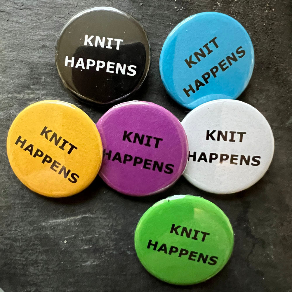 Six KNIT HAPPENS pin badges in black, blue, pink, green, yellow, and white.
