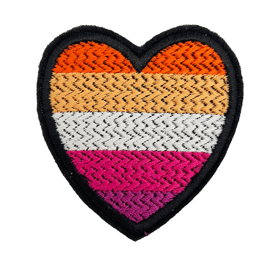A close-up view of a heart-shaped embroidered felt patch featuring the lesbian pride flag colors: dark orange, orange, white, pink, and dark pink stripes.