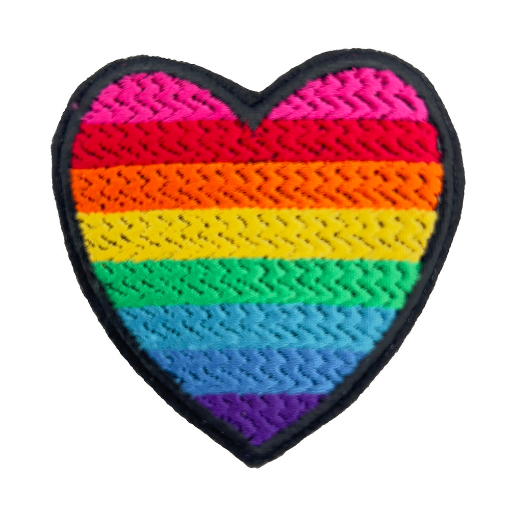 A heart-shaped embroidered patch with the rainbow colors of the original gay pride flag. The patch is displayed against a plain white background.