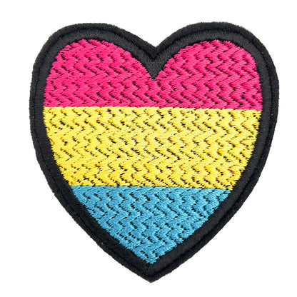 A heart-shaped embroidered patch with the colors of the pansexual pride flag: pink at the top, yellow in the middle, and blue at the bottom. The patch is displayed against a plain white background.