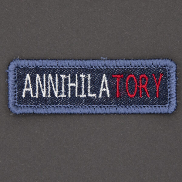blue denim patch embroidered with the word ANNIHILATORY