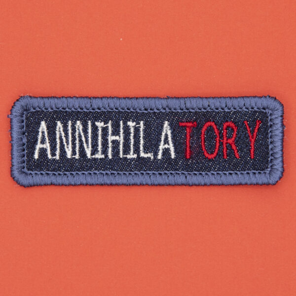 blue denim patch embroidered with the word ANNIHILATORY