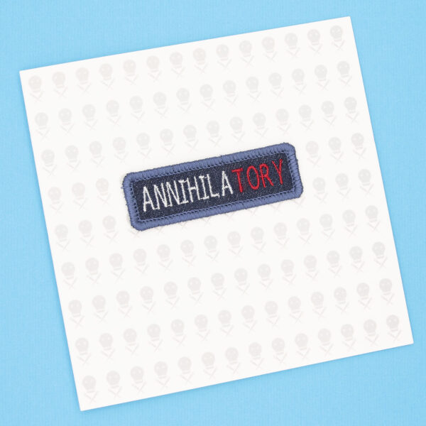gift card with blue denim patch embroidered with the word ANNIHILATORY