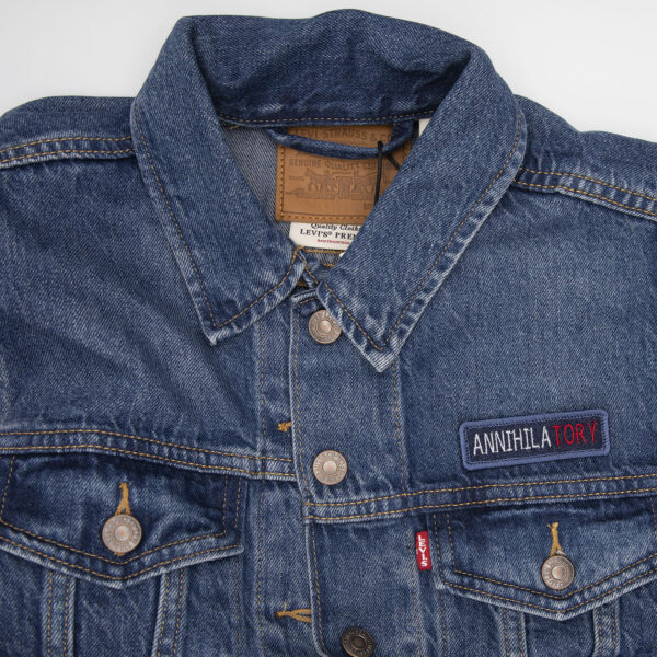 denim jacket with blue denim patch embroidered with the word ANNIHILATORY