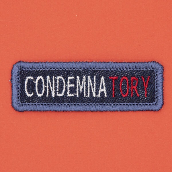 blue denim patch embroidered with the word CONDEMNATORY