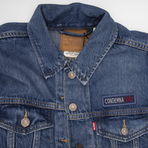 demin jacket with blue denim patch embroidered with the word CONDEMNATORY