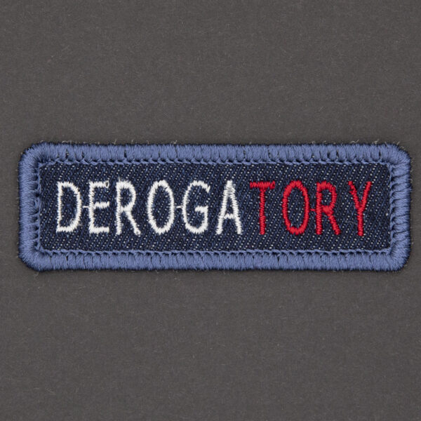 blue denim patch embroidered with the word DEROGATORY