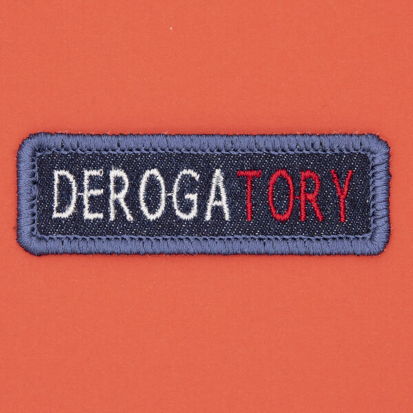 blue denim patch embroidered with the word DEROGATORY