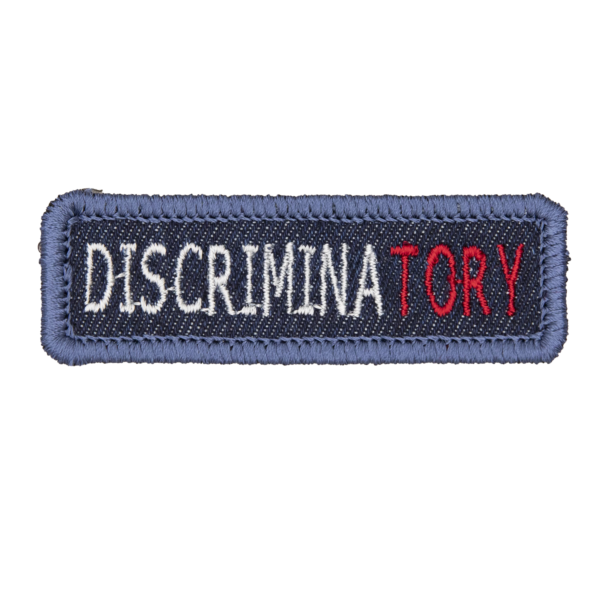 blue denim patch embroidred with the word DISCRIMNATORY
