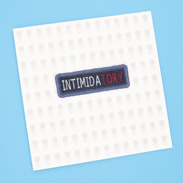 gift card with blue denim patch embroidered with the word INTIMIDATORY