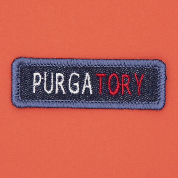 blue denim patch embroidered with the word PURGATORY
