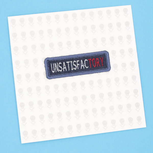 gift card with blue denim patch embroidered with the word UNSATISFACTORY