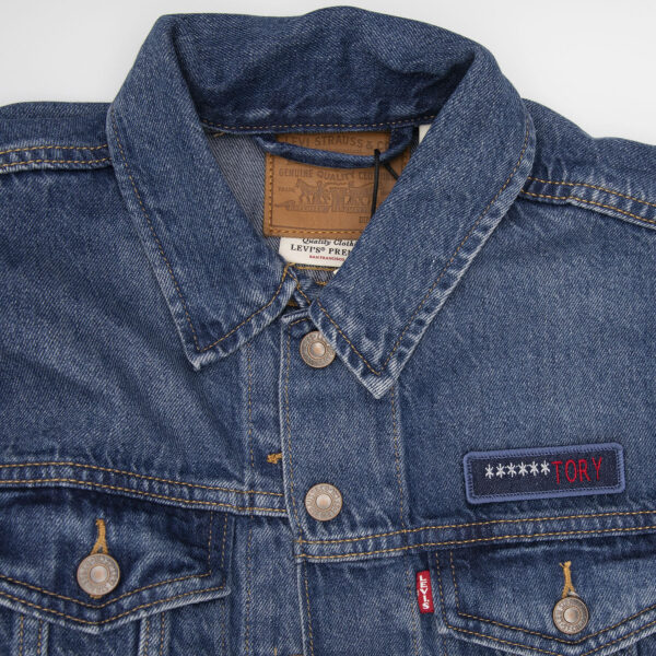 demin jacket with blue denim patch embroidered with the word ******