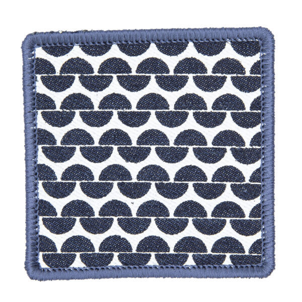 patch made from blue denim screen printed with a garter stitch print and finished with an embroidered border