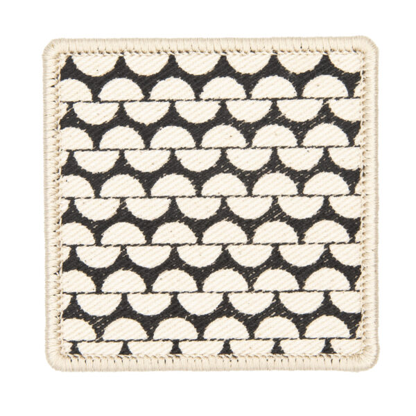patch made from cream denim screen printed with a garter stitch print and finished with an embroidered border
