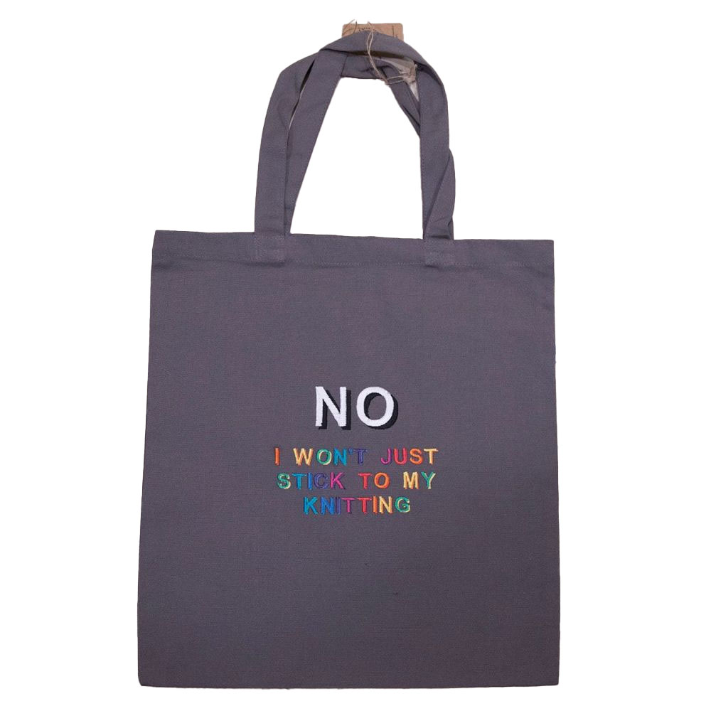 grey tote bag embroidered with "NO I WON'T JUST STICK TO MY KNITTING" in rainbow colours