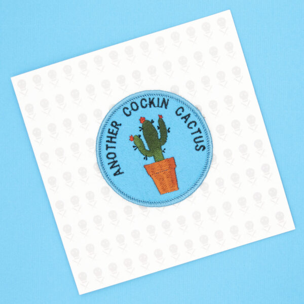 round embroidered patch picture of cactus in pot and text another cockin cactus on turquoise blue