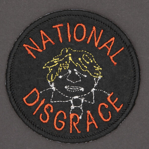 round embroidered patch line drawing of Boris Johnson and the words National Disgrace