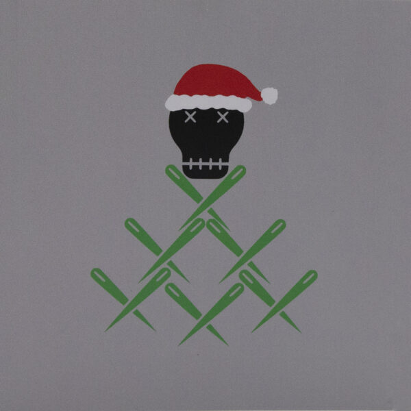 Front of card for decorations - the Unruly Stitch skull wears a santa hat and sits on a pile of green sewing needles