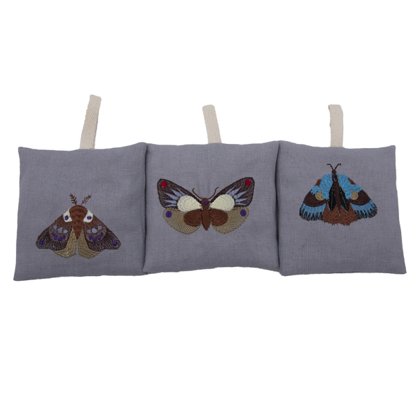 set of three silver linen bags embroidered with moths