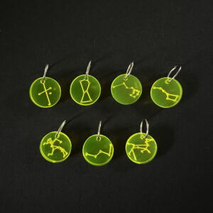 Seven constellations on discs laser cut from fluorescent yellow perspex. Mounted on a jump rings to create stitch markers.