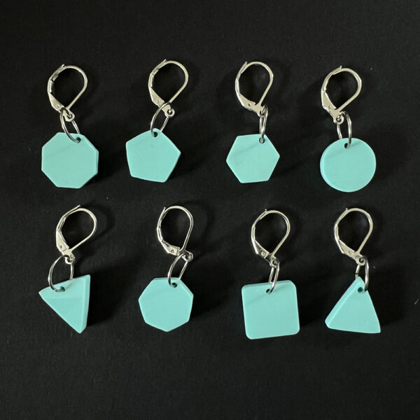 Eight geometric shapes laser cut from spearmint green pastel perspex. Mounted on latch back hooks to create stitch markers.