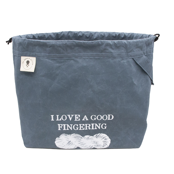 large slate blue drawstring project bag. The bag is printed with text "I LOVE A GOOD FINFERING" and a skein of yarn in white ink. The bag has a handle, a drawstring and a cream label with The Unruly Stitch logo