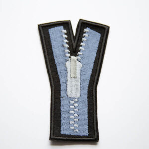 Embroidered patch showing a blue zip with silver teeth and pull on black felt.
