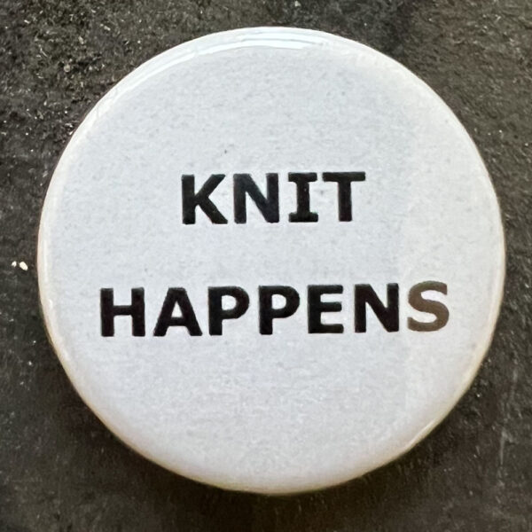 Pin badge with the words KNIT HAPPENS. Black text, white background.
