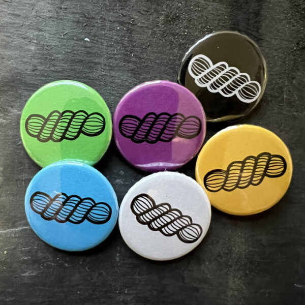 Six badges with a line drawing of a skein of yarn. Black lines on blue, yellow, green, pink and white, white lines on black background.