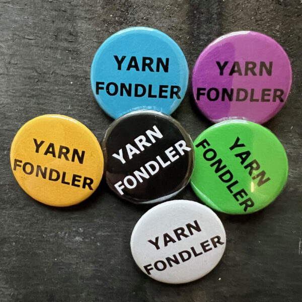 Six badges with the words YARN FONDLER. Black text on blue, yellow, green, pink and white, white text on black background.