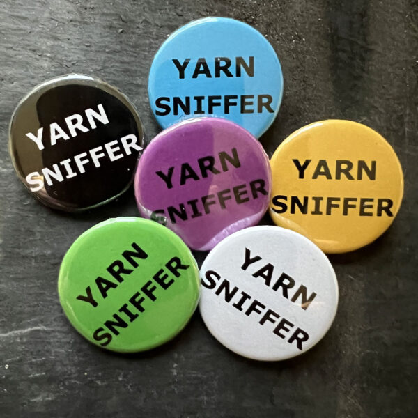 Six badges with the words YARN SNIFFER. Black text on blue, yellow, green, pink and white, white text on black background.